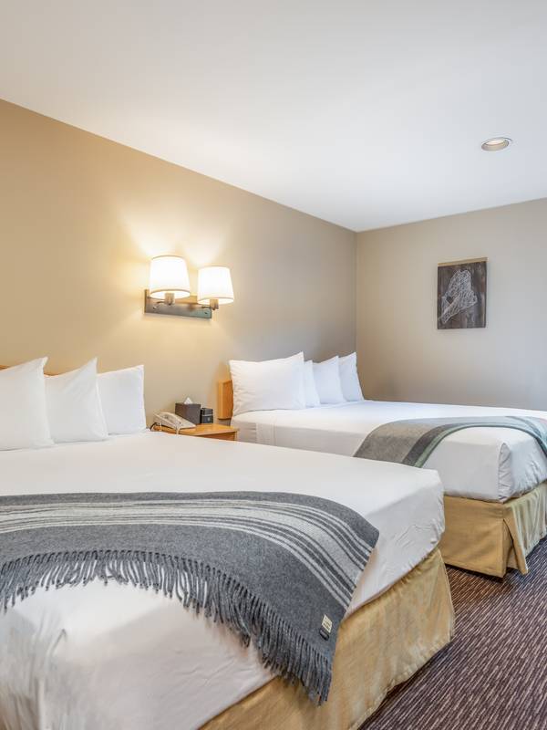 Two queen beds made at the Snow Capp Inn at Sunday River.