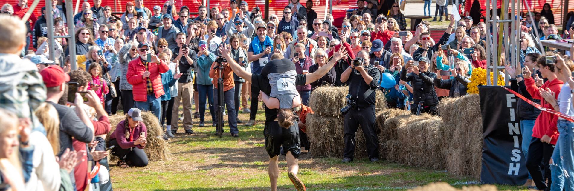 Participants crossing the finish line at the North American Wife Carrying Championship at Sunday River.
