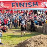 A participant crossing the finish line at the North America Wife Carrying Competition at Sunday River.