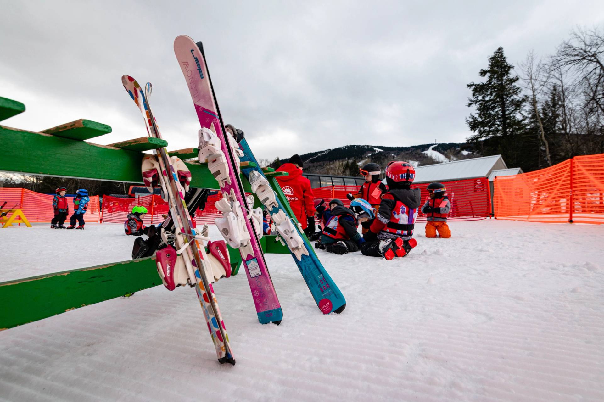 Small skis for children in a ski rack.