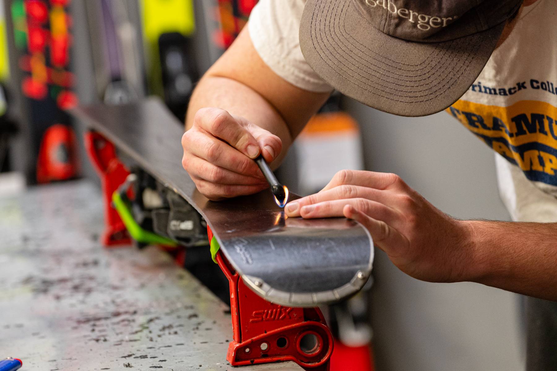 A person working on a repair on a set of skis at Sunday River.