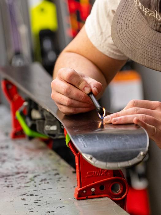A man tuning skis at Sunday River's tune shop.