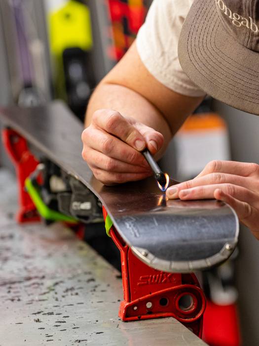 A man tuning skis at Sunday River's tune shop.