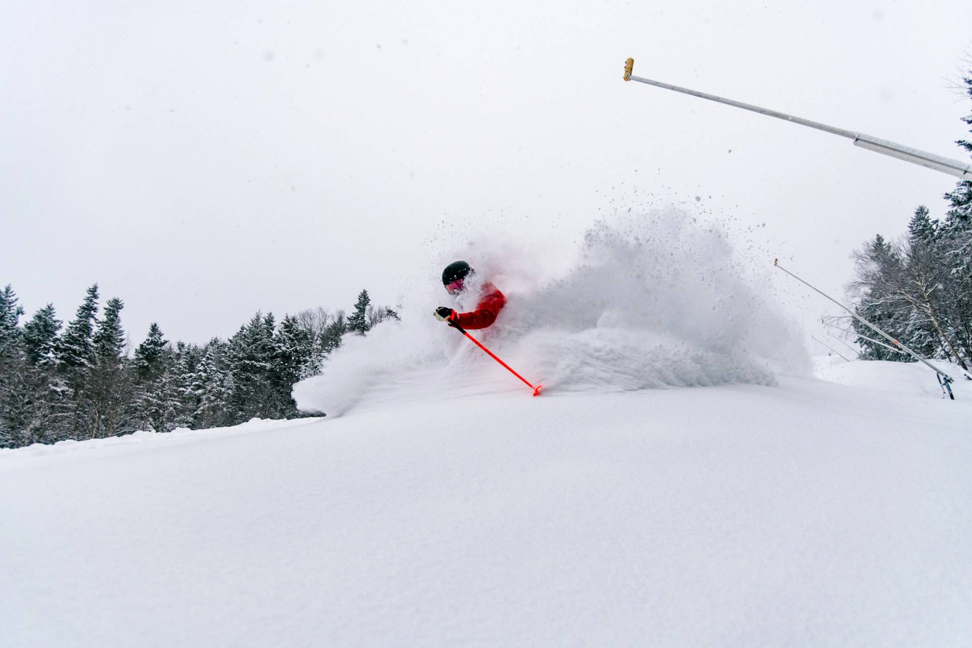 A man skiing in powder at Sunday River.