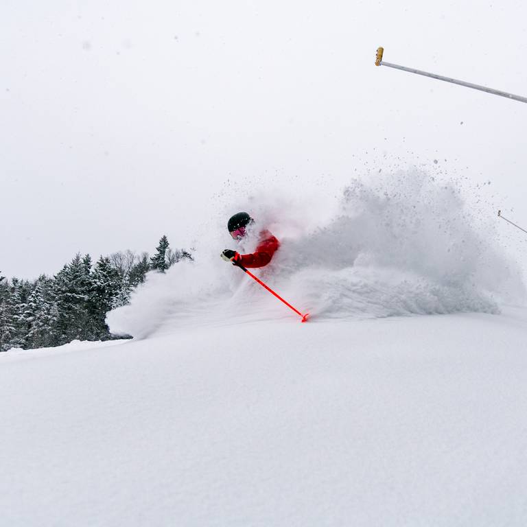 Skier in fresh powder at Sunday River.