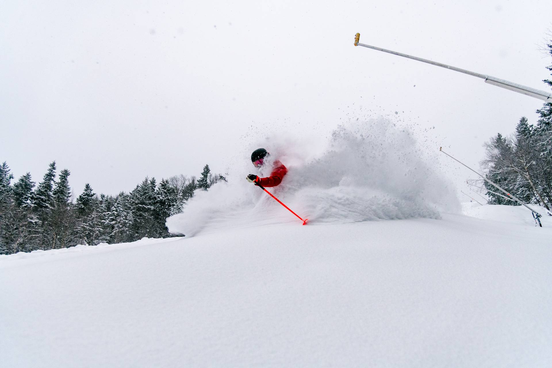 A man skiing in powder at Sunday River.