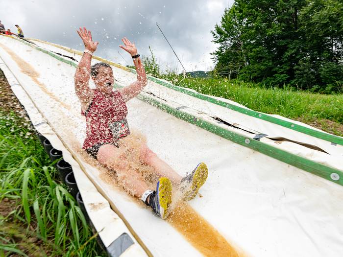 A person on the water slide at Tough Mountain Challenge