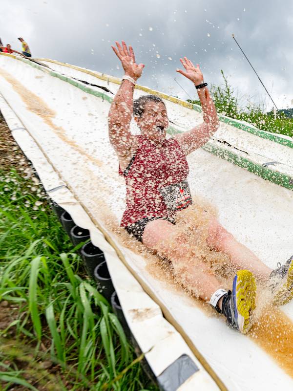 A person on the water slide at Tough Mountain Challenge