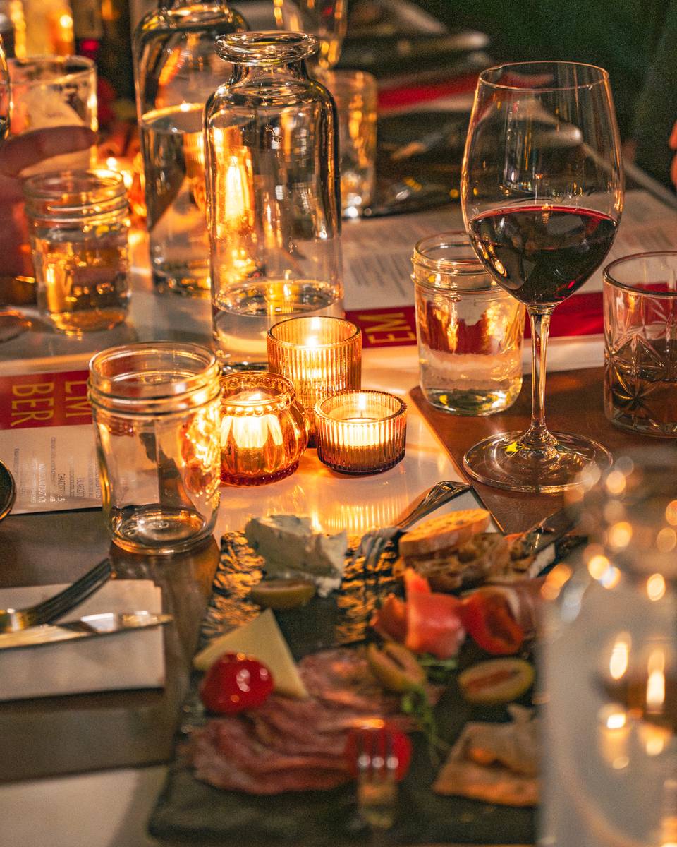 A table of candles and dishes at Sunday River's Ember.