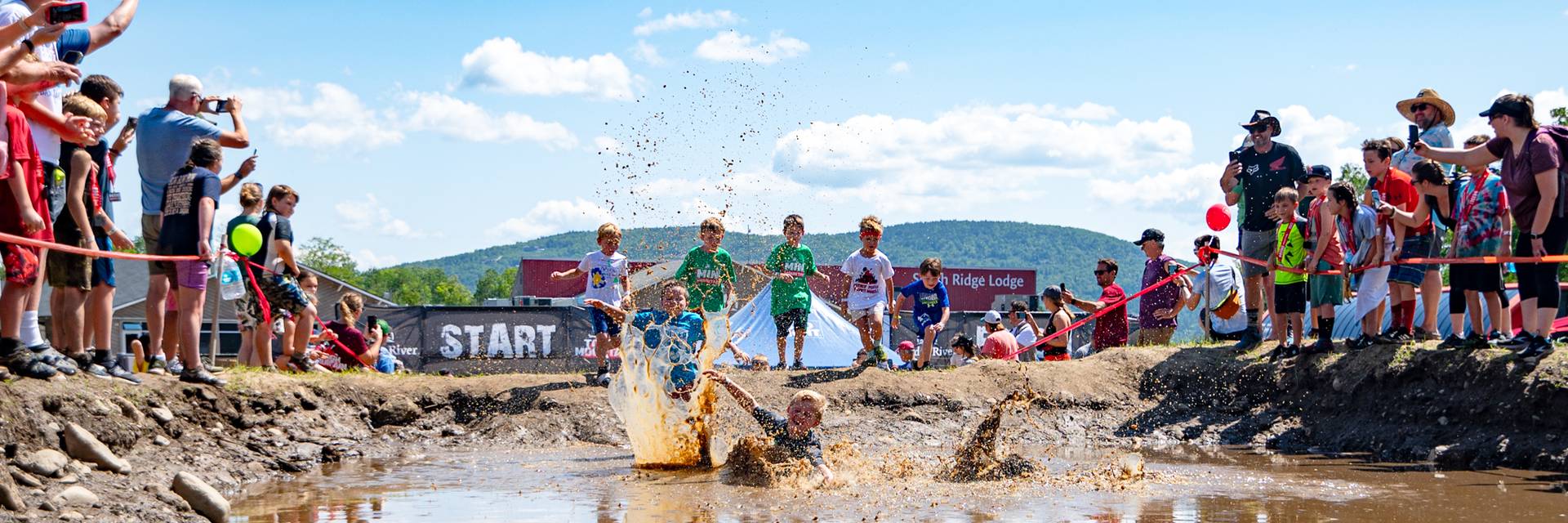 Kids jumping in the mud at the Mini Mountain Challenge at Sunday River.