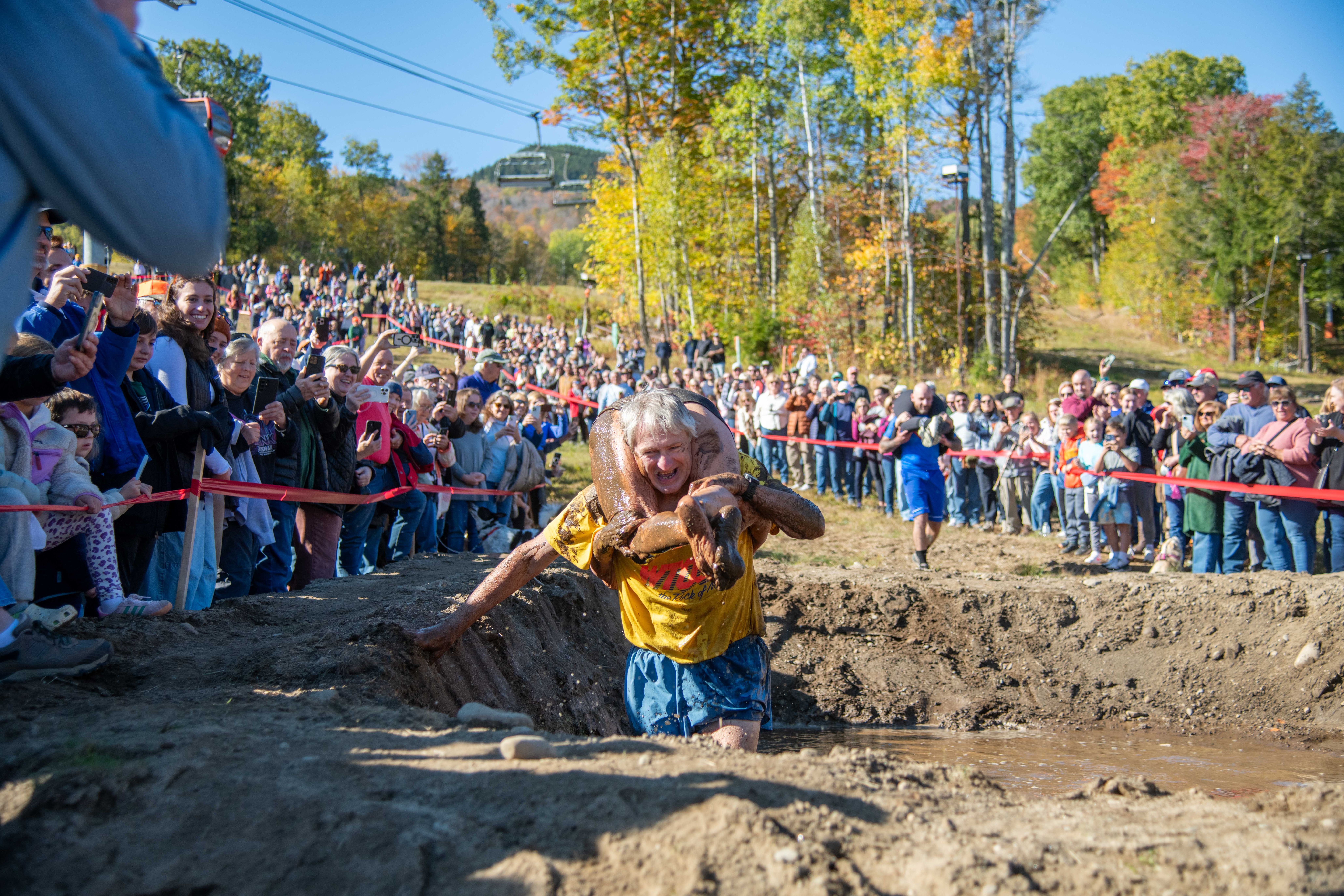 Contestants participating in wife carrying in a mud pit at Sunday River.