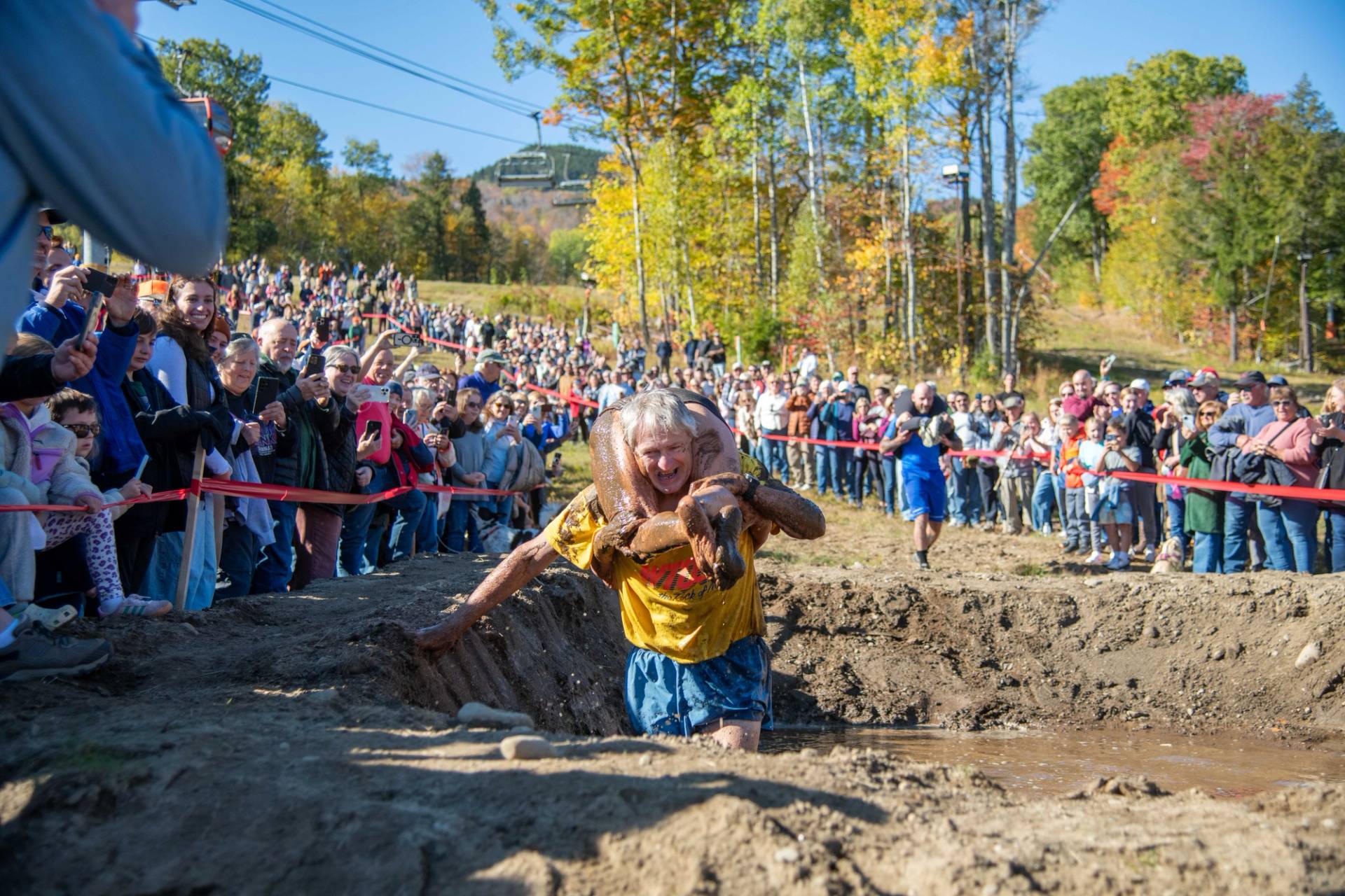 Contestants participating in wife carrying in a mud pit at Sunday River.