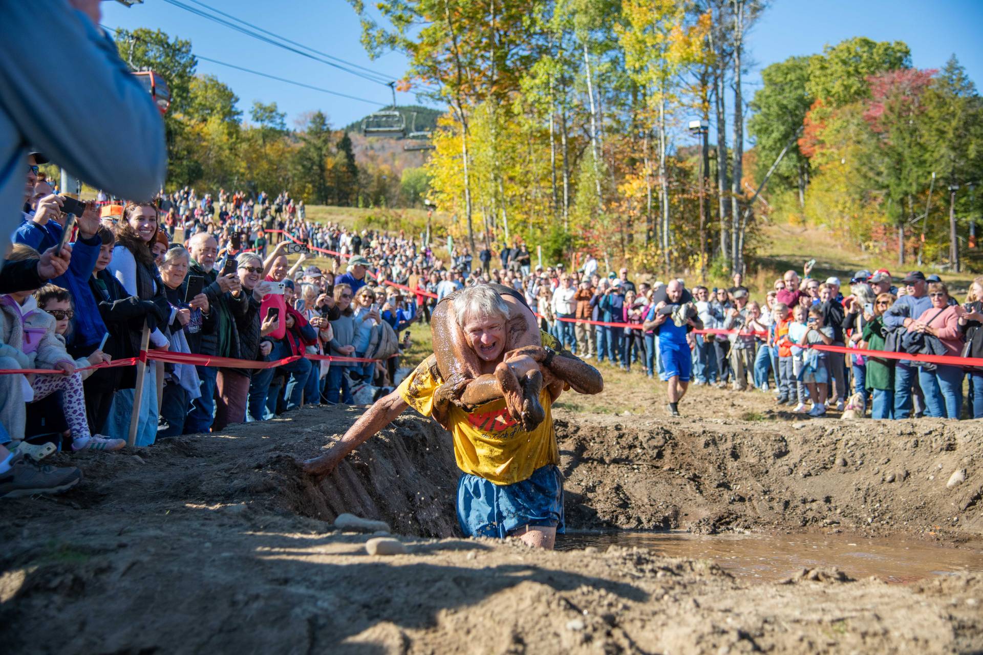 Contestants participating in wife carrying in a mud pit at Sunday River.