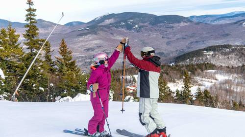 Two people high-fiving at Sunday River.