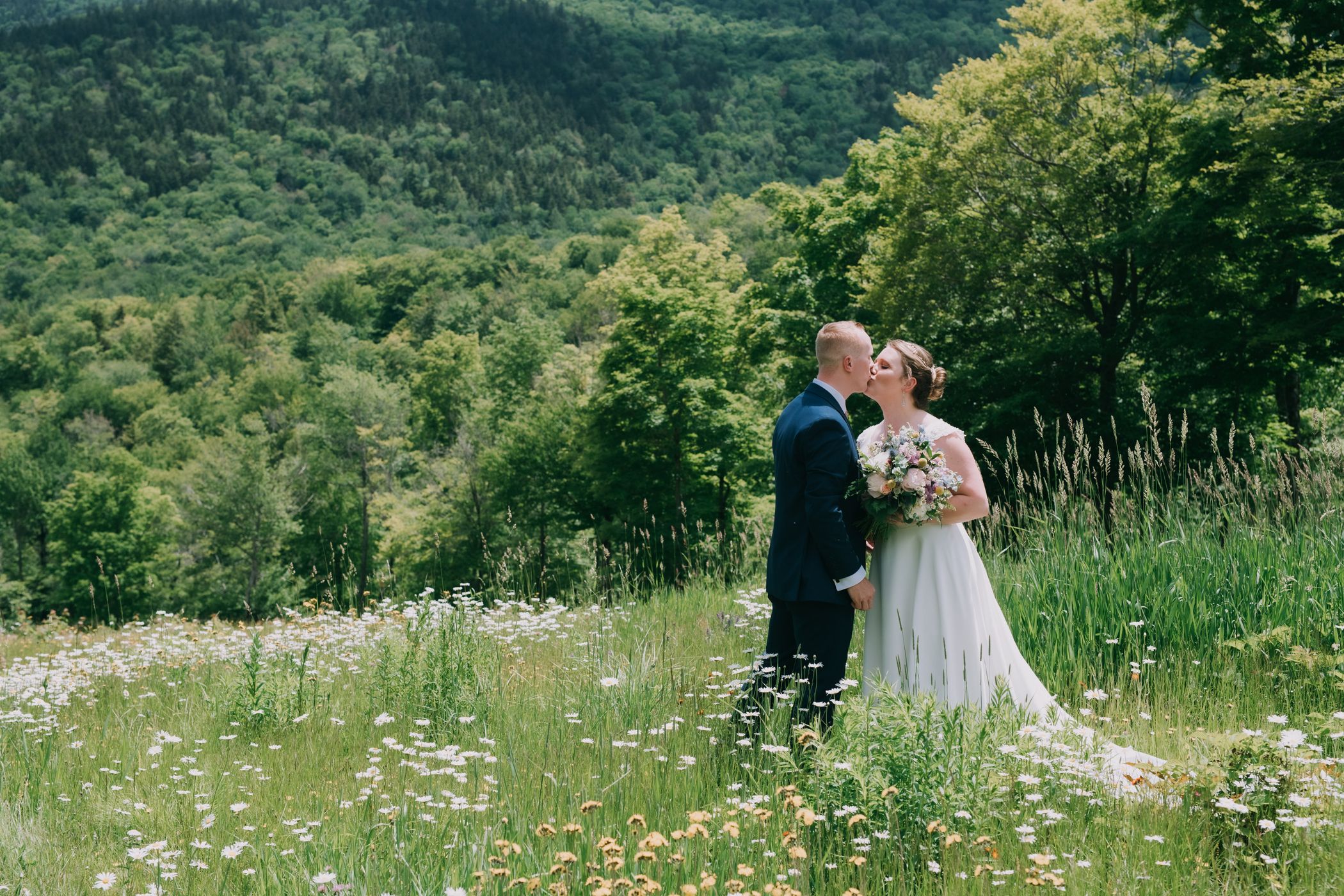 A husband and wife talking on a path with leaves at Sunday River.