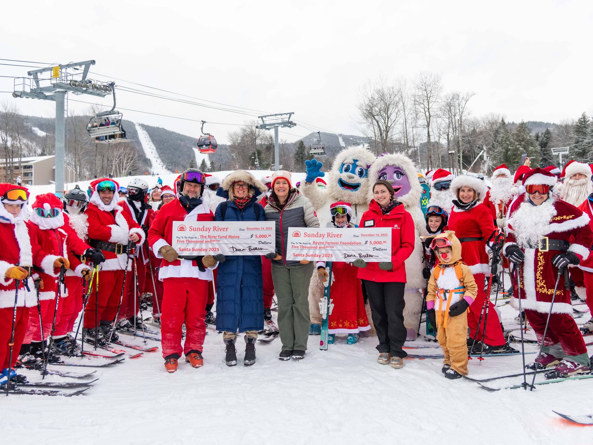 People posing for a picture at a check presentation at Santa Sunday.
