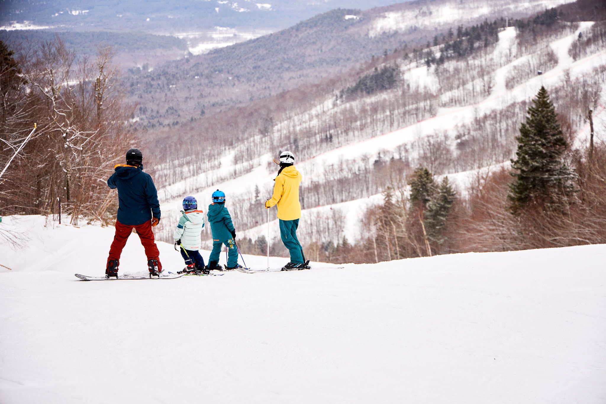 A family looking out at the view while they ski.