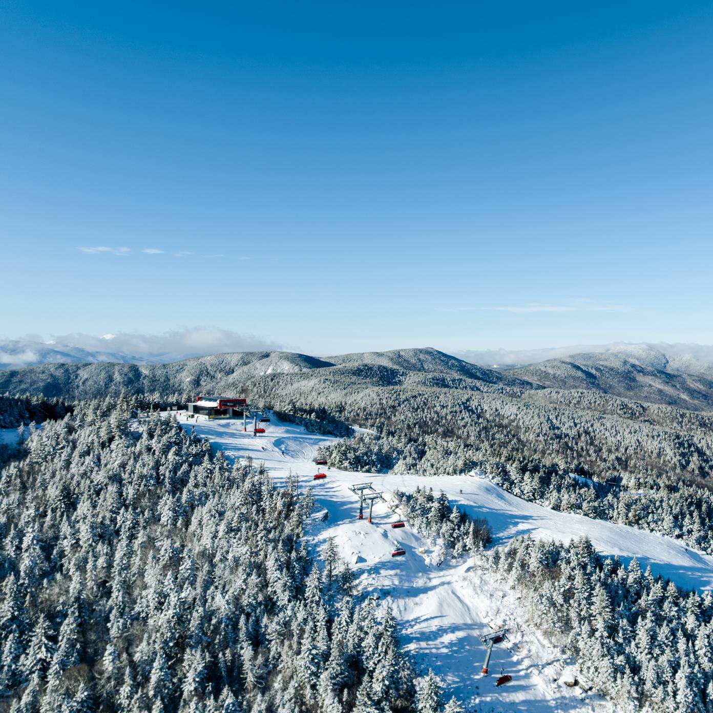 The Jordan 8 at Sunday River with snow, mountains, and trees.