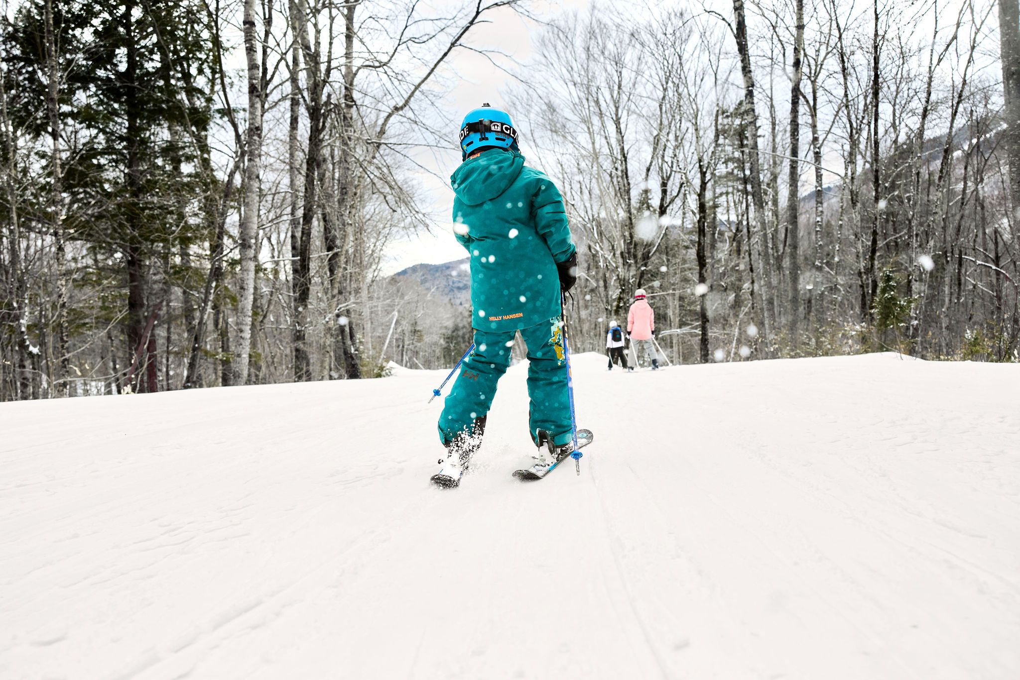 A kid skiing in a blue outfit at Sunday River.