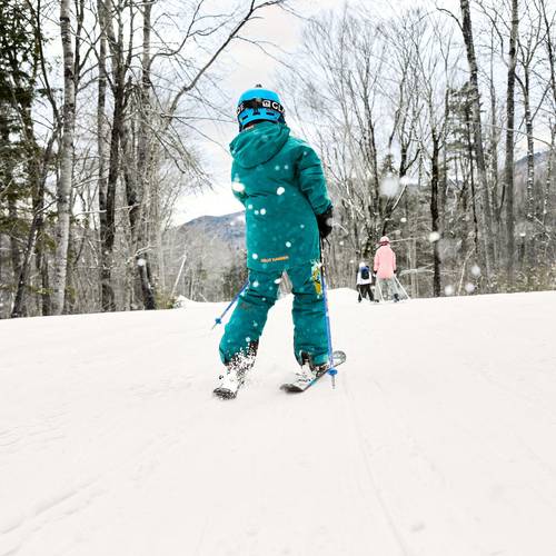 A kid skiing in a blue outfit at Sunday River.