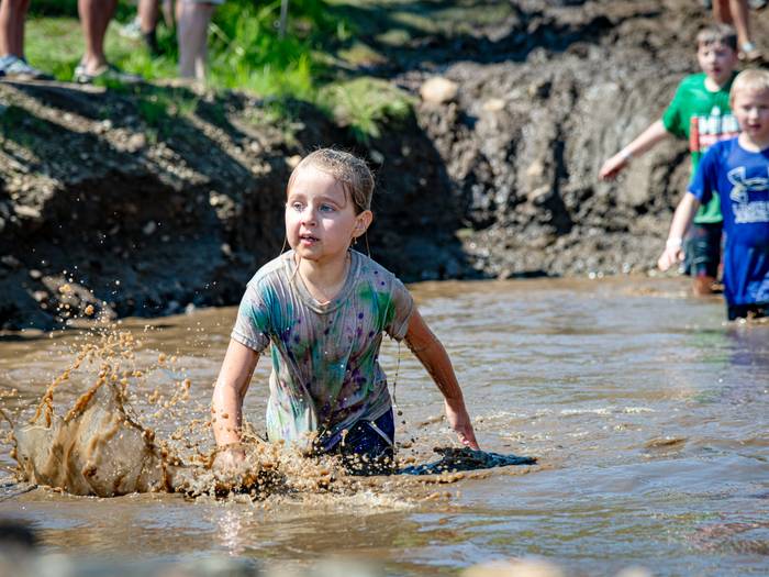 Kids walking through the mud pit at the Mini Mountain Challenge at Sunday River.