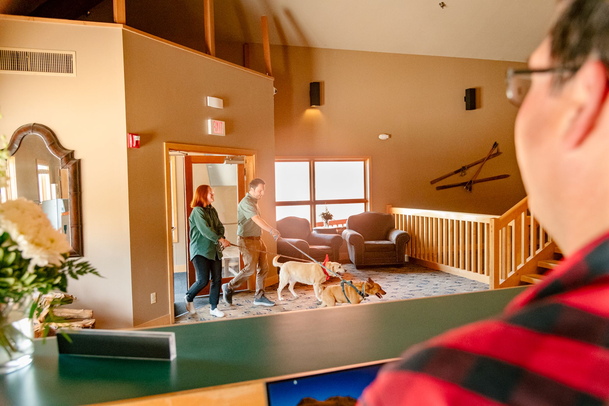 People walking into the Snow Cap Inn with dogs.