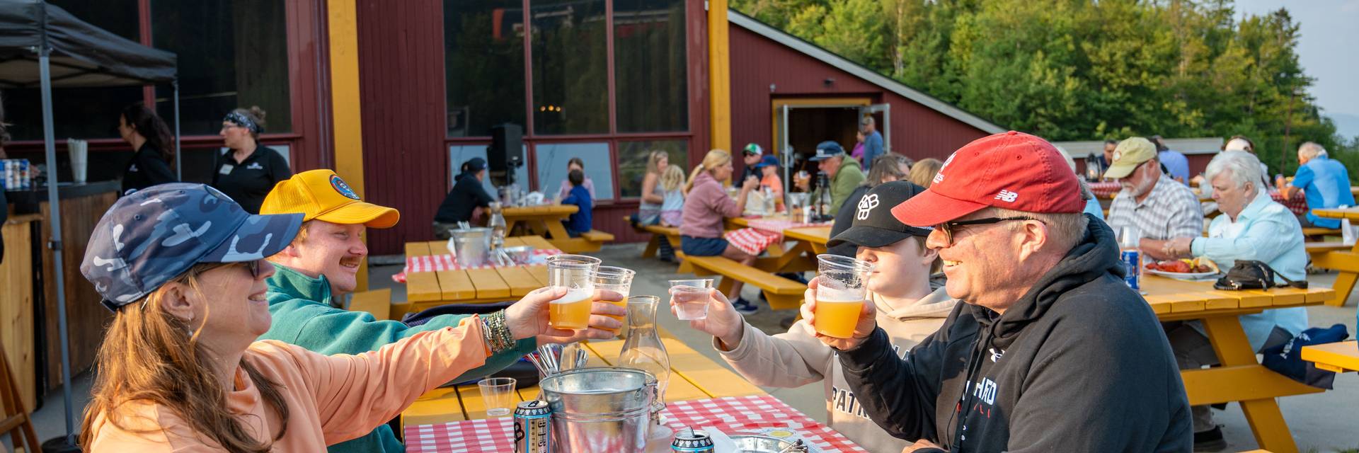 People sitting and enjoying the lobster bake at Sunday River.