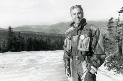 A photo of Les Otten standing on a trail at Sunday River.