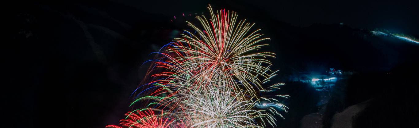Fireworks exploding in the winter at Sunday River in South Ridge.