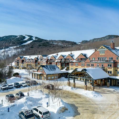 Jordan Hotel at Sunday River in the winter with the mountains in the background.