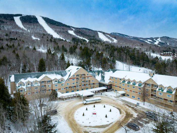 The Grand Summit in the winter with mountains behind it.