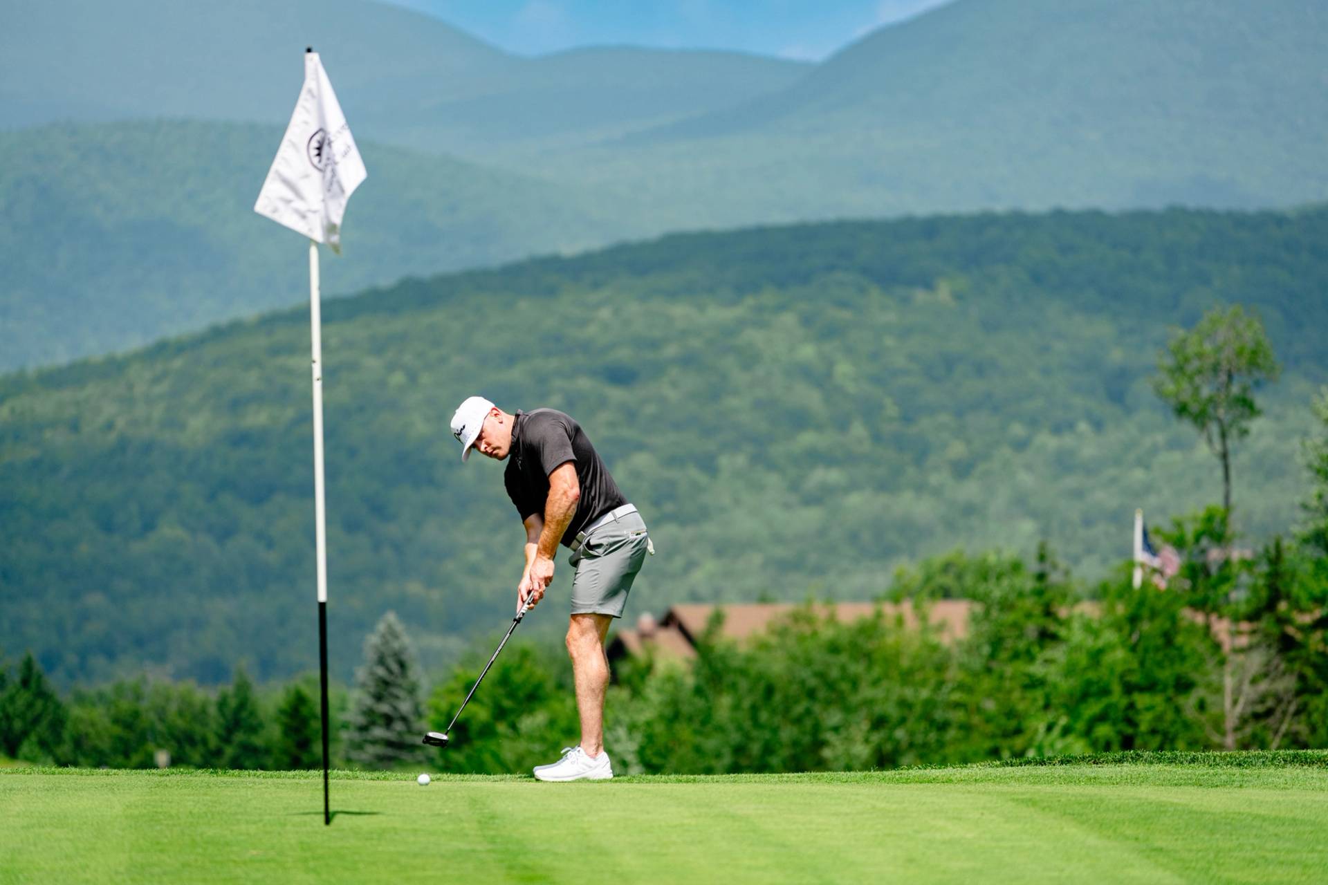 Golfer putting at Sunday River Golf Club.