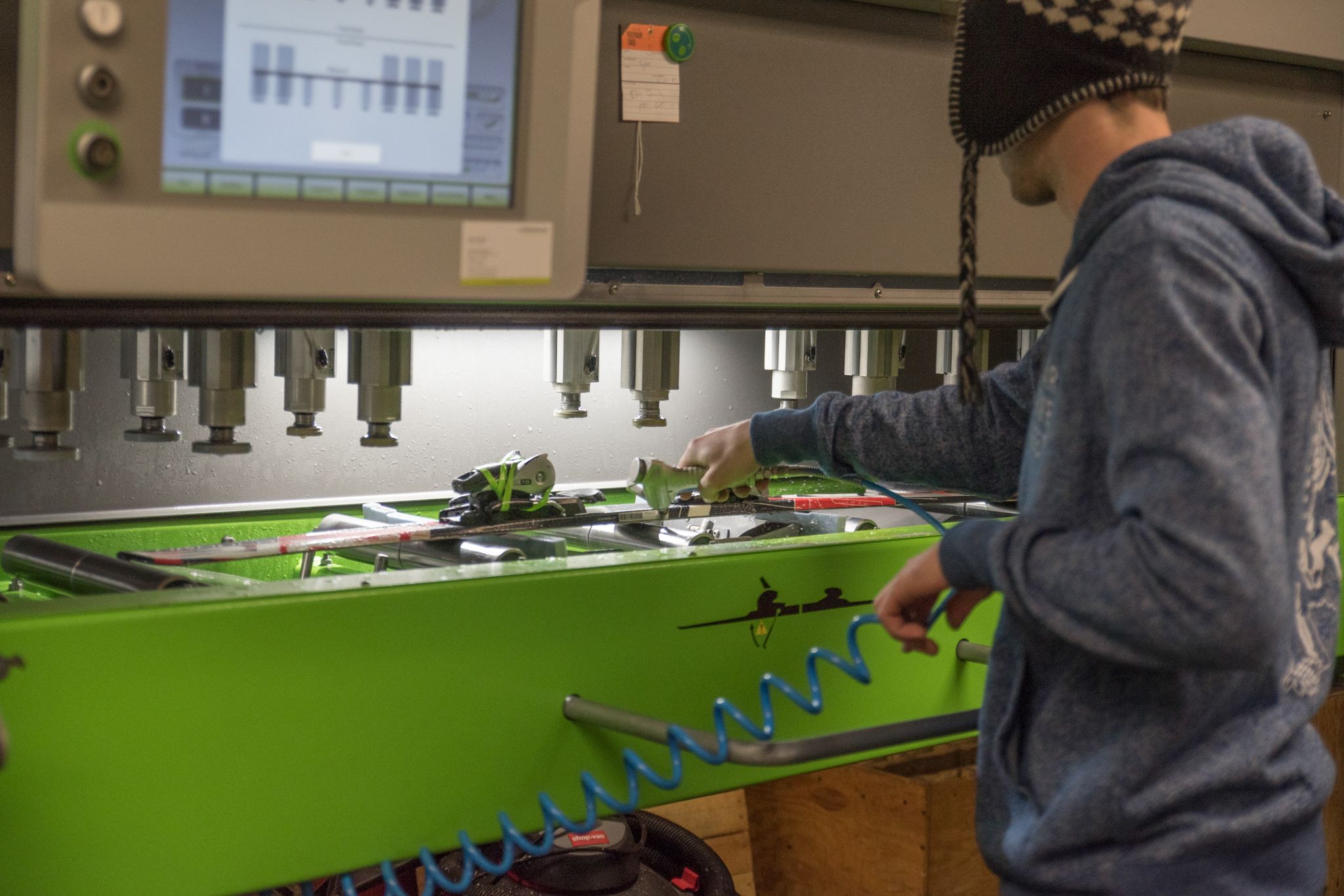 A tune shop expert tuning a pair of skis at Sunday River.