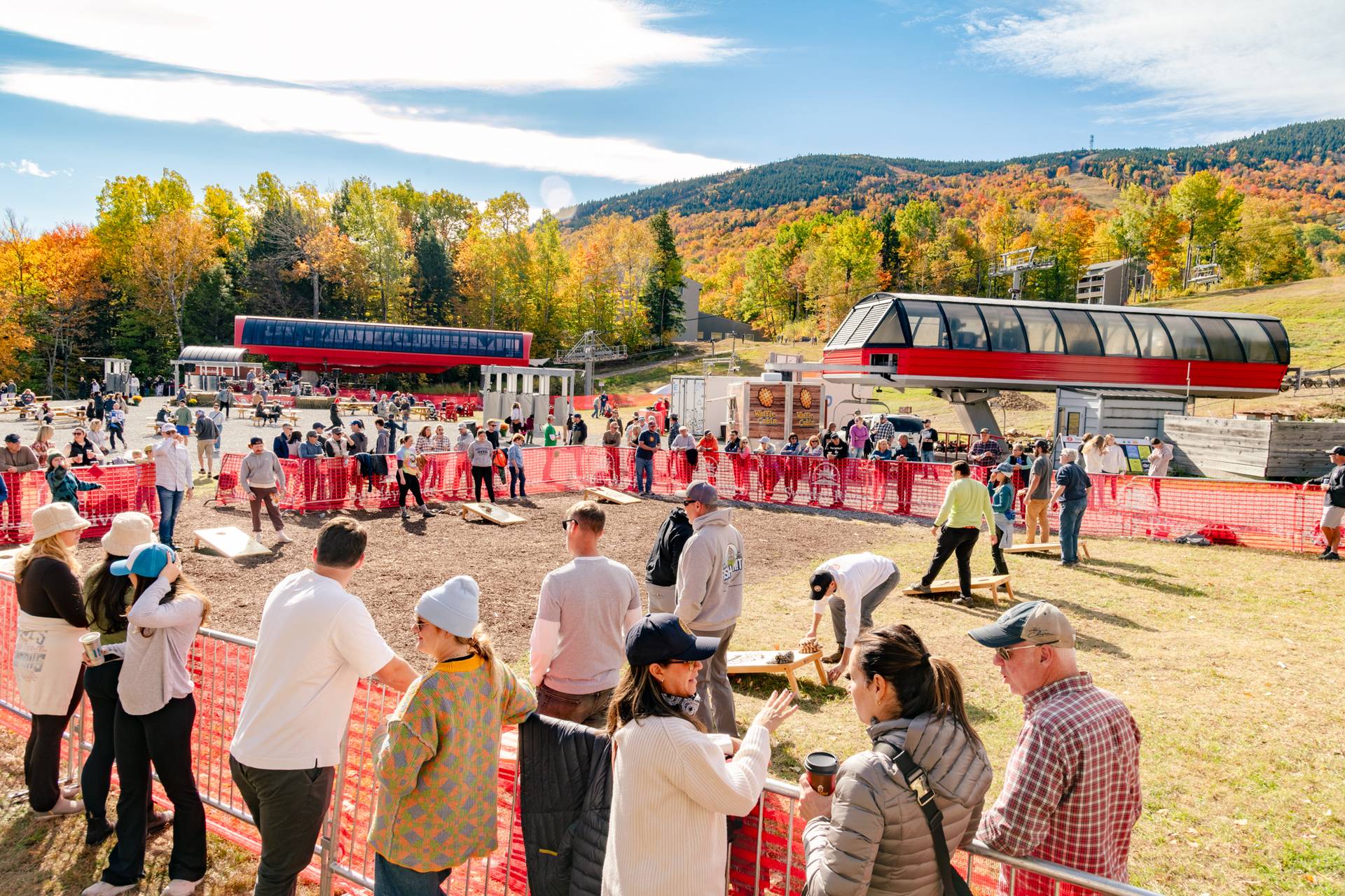 A group of people watching the New England Cornhole tournament at Sunday River's Fall Fest.