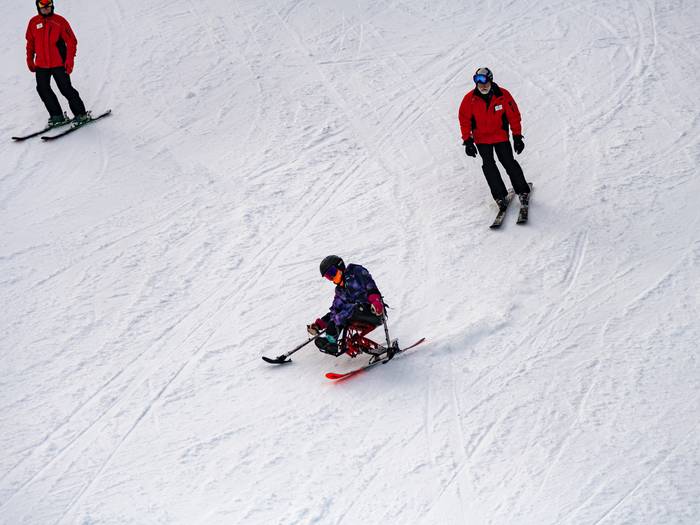A skier skiing with Maine Adaptive at Sunday River, Newry Maine