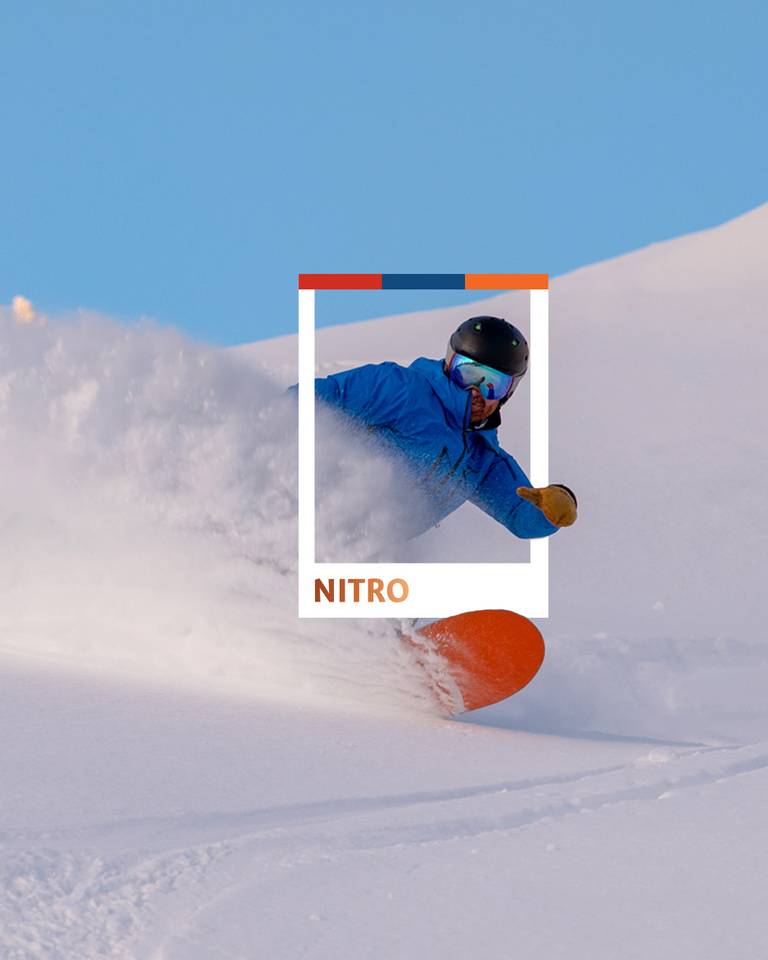 A snowboarder in powder at Sunday River.