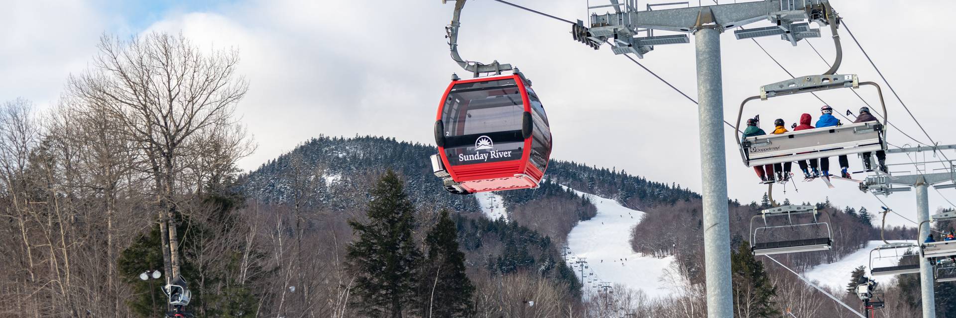 People skiing by the Chondola at Sunday River.