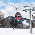 People skiing by the Chondola at Sunday River.