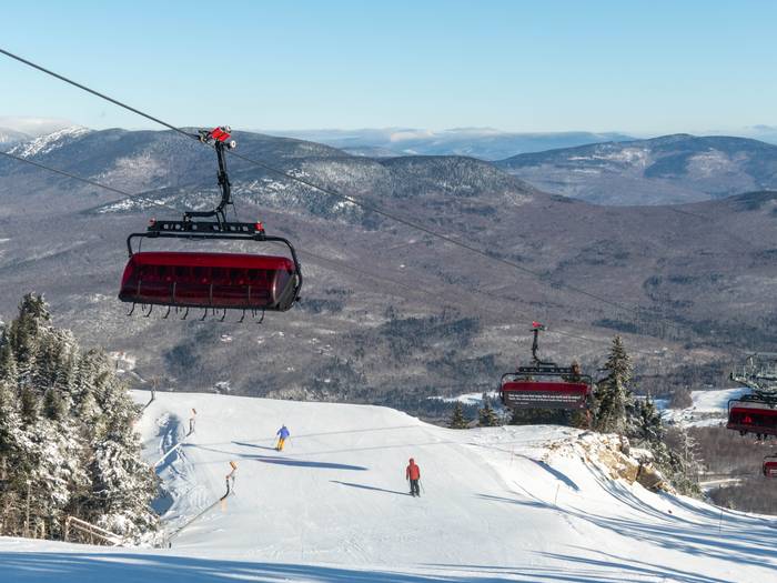 People skiing under the chairs of the Jordan 8 at Sunday River.