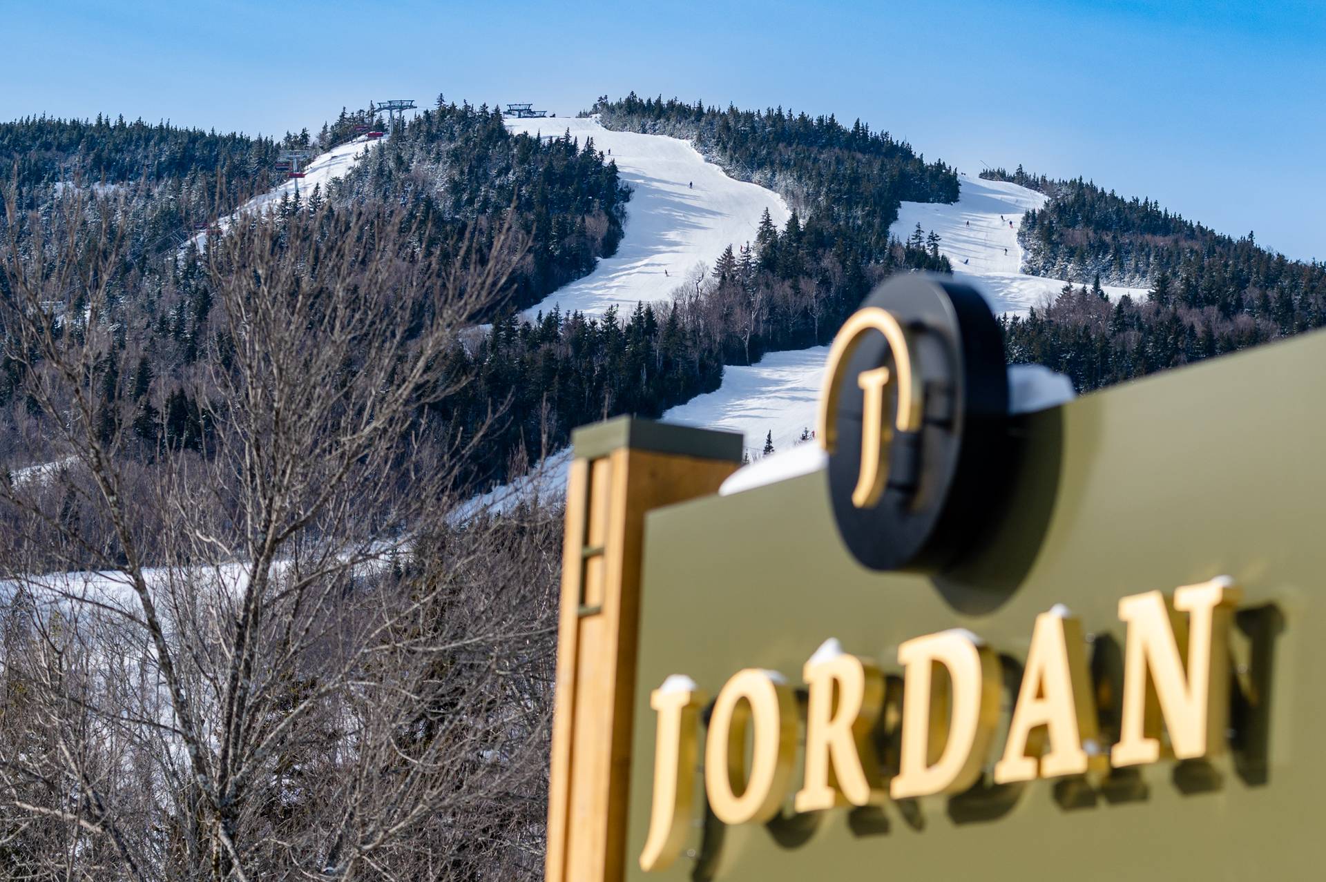 The Jordan hotel sign with Jordan Bowl in the background.