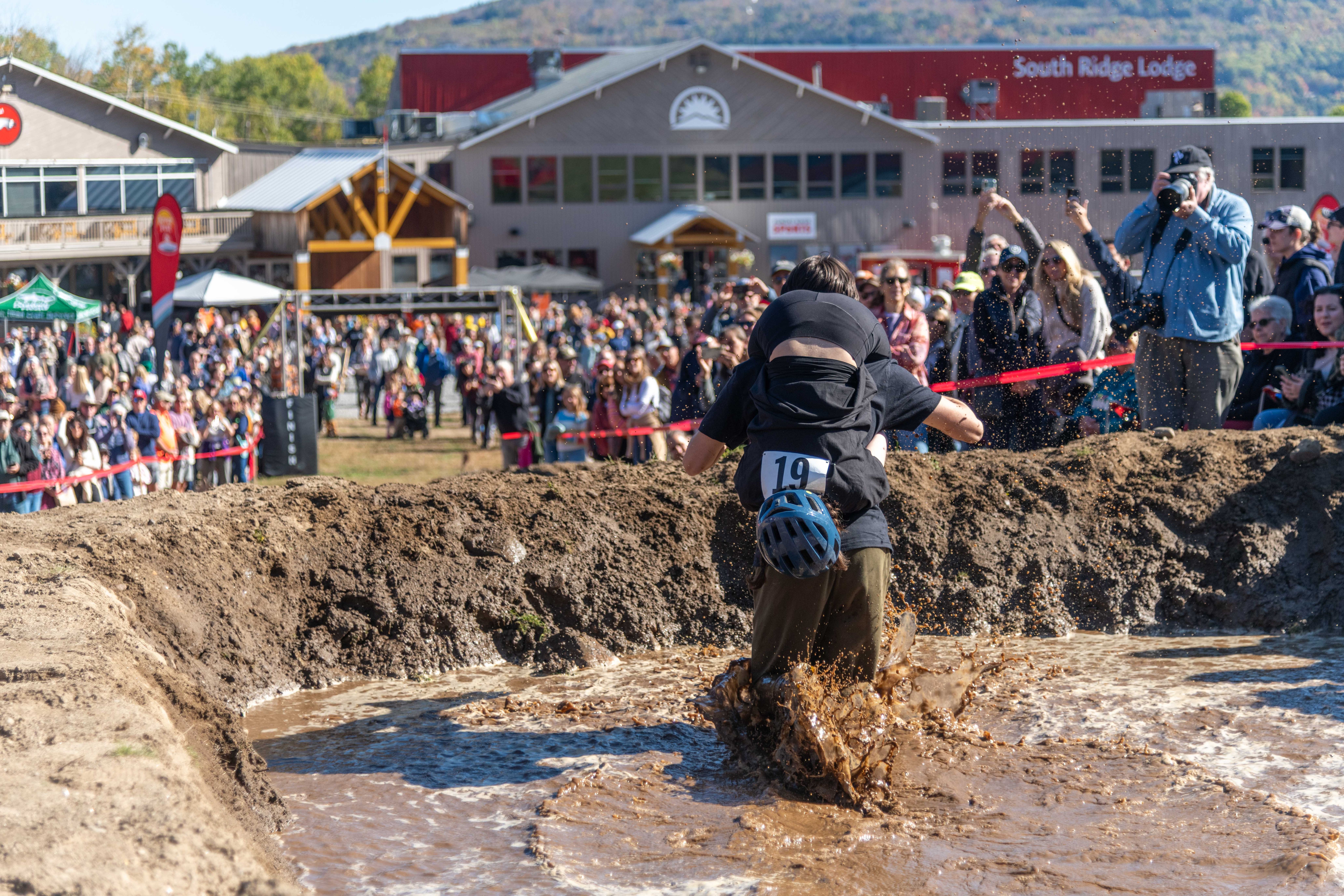 A couple participating in the North American Wife Carrying competition at Sunday River.