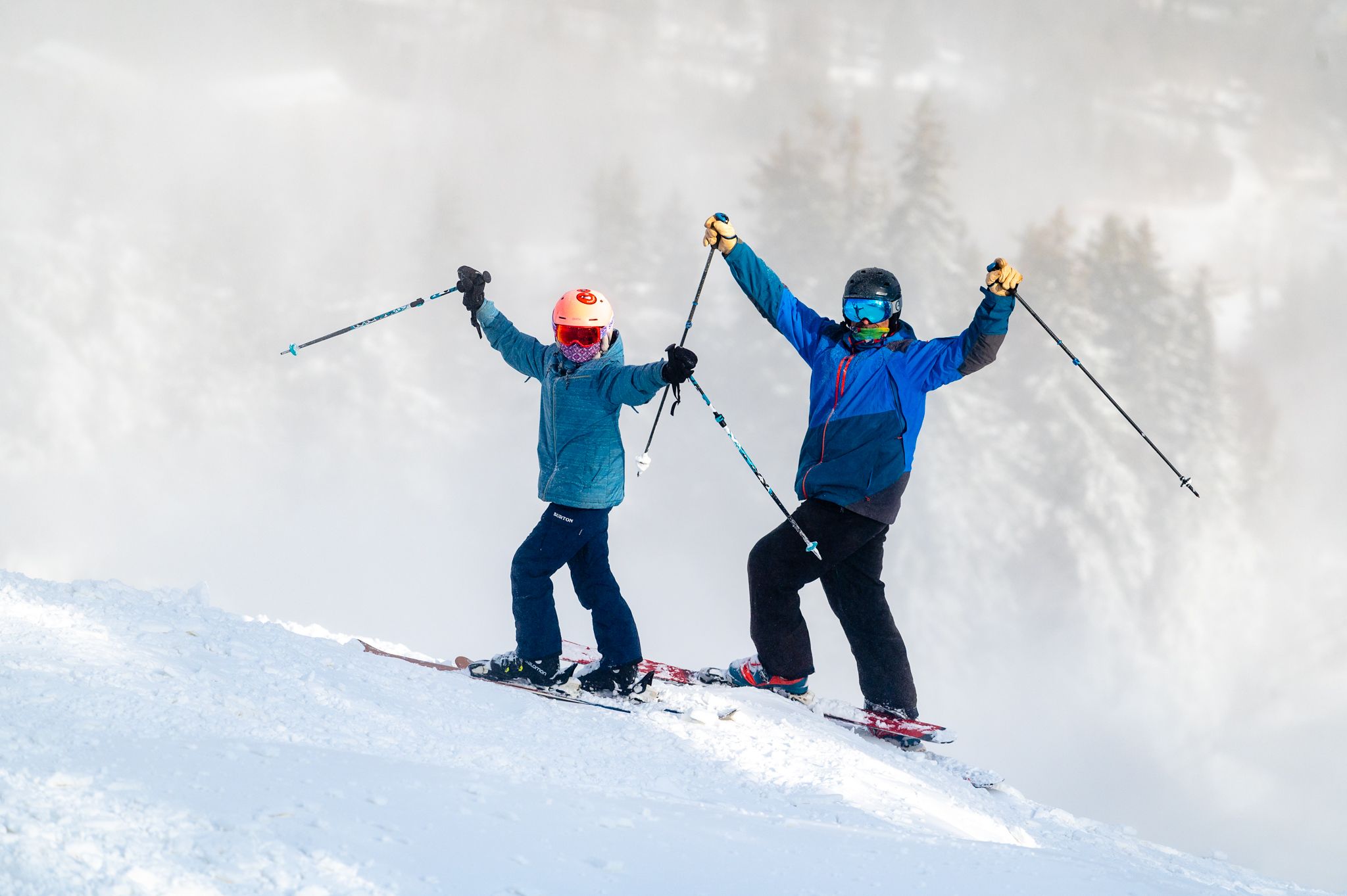 Two skiers posing in excitement at Sunday River.