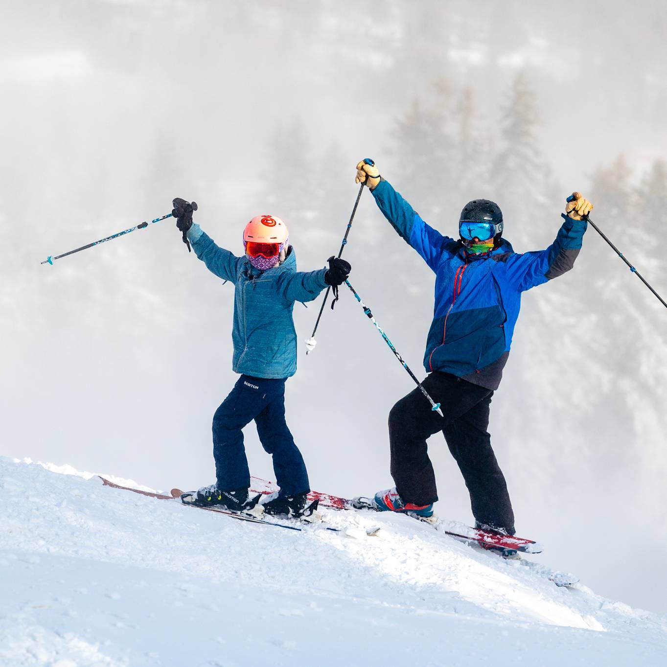 Two skiers posing in excitement at Sunday River.