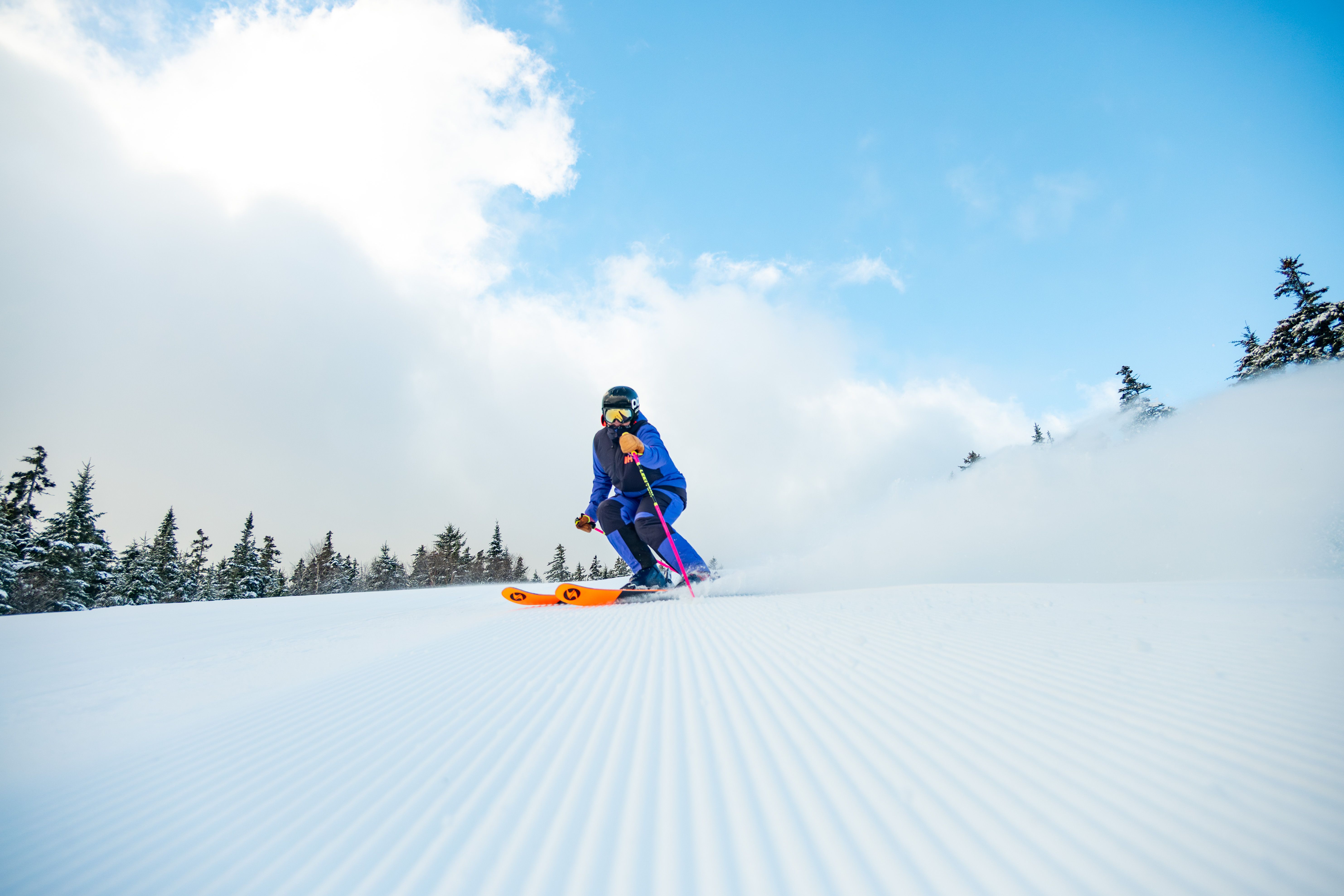 A person skiing down a trail.