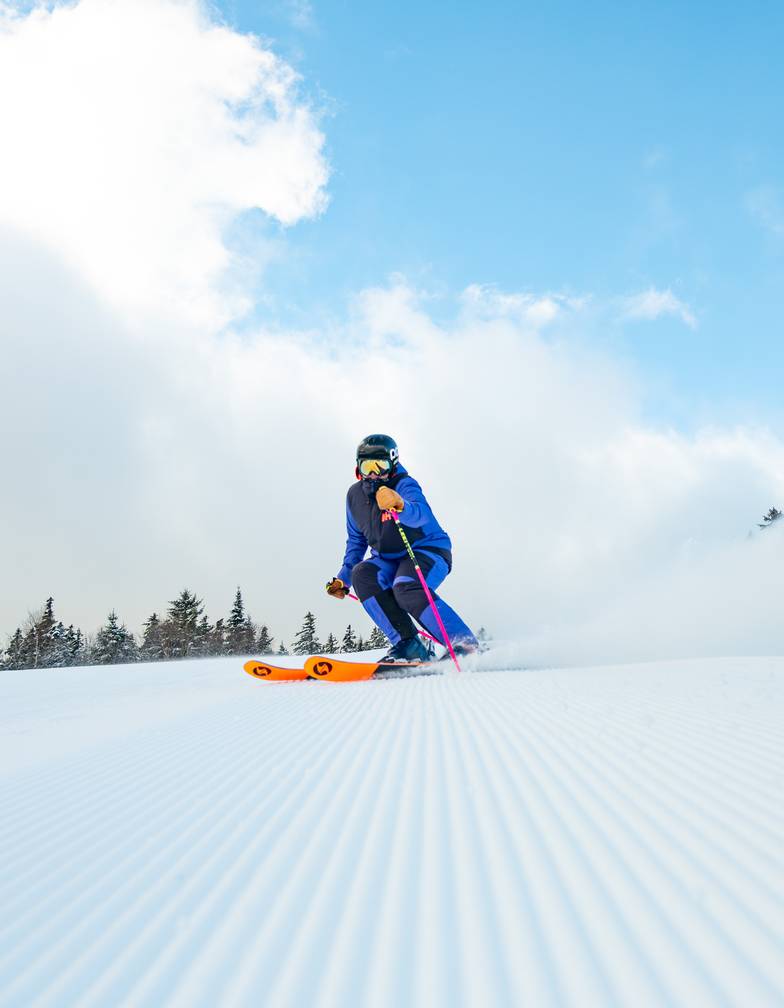 Skier carving fresh corduroys at Sunday River