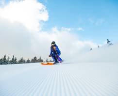 A person skiing down a trail.
