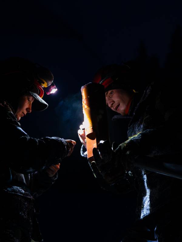 Snowmakers working in the dark at Sunday River.