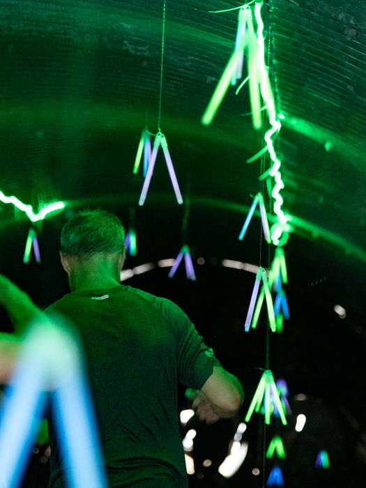 People walking through a glow tunnel at Sunday River's Tough Mountain Challenge.