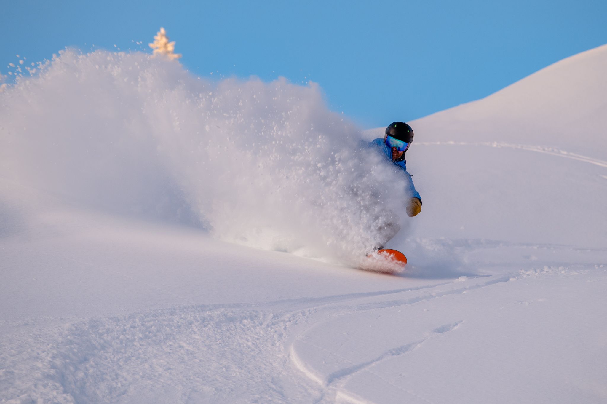 A person shredding on a snowboard at Sunday River.