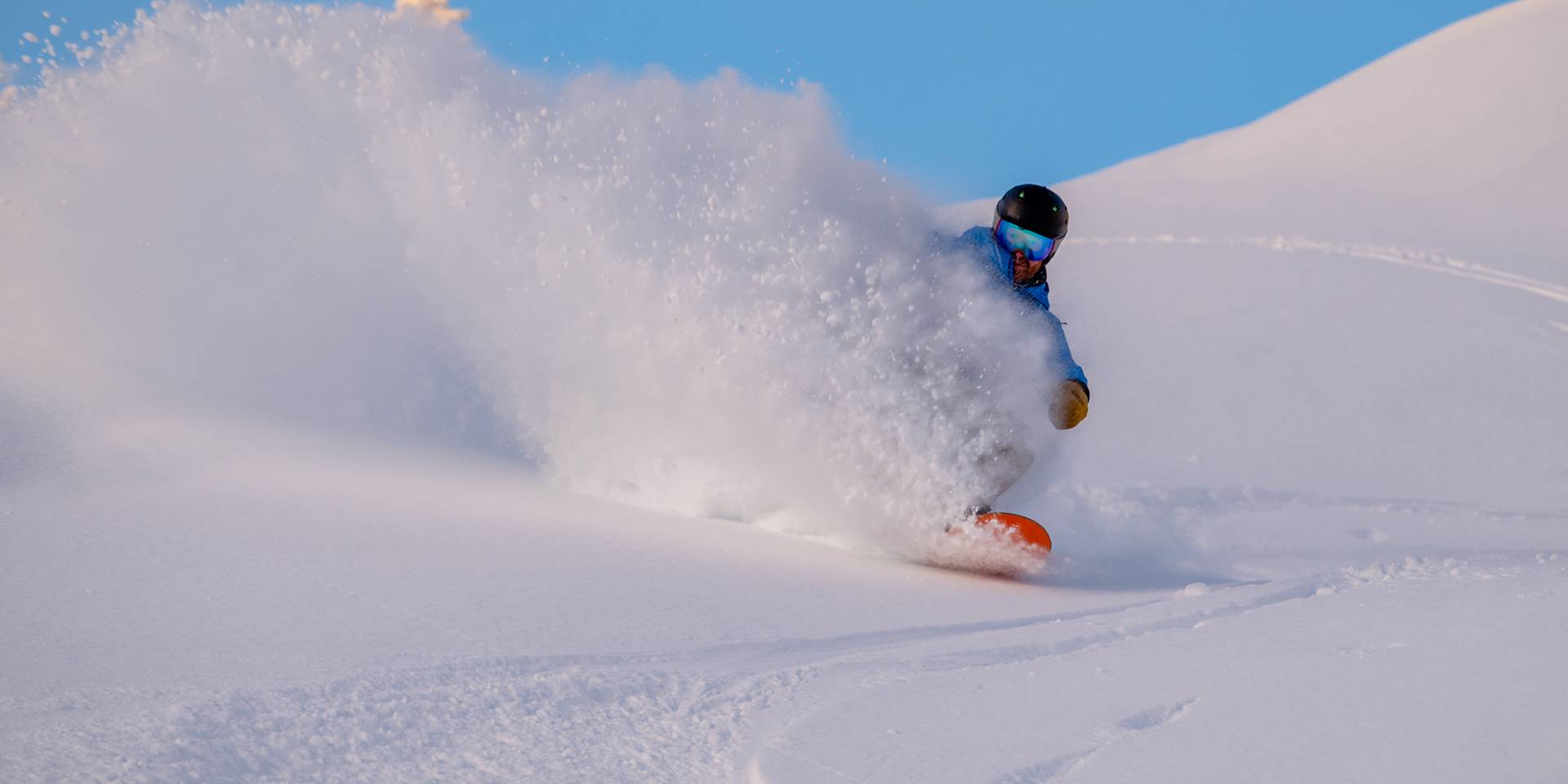 A snowboarder shredding at Sunday River.